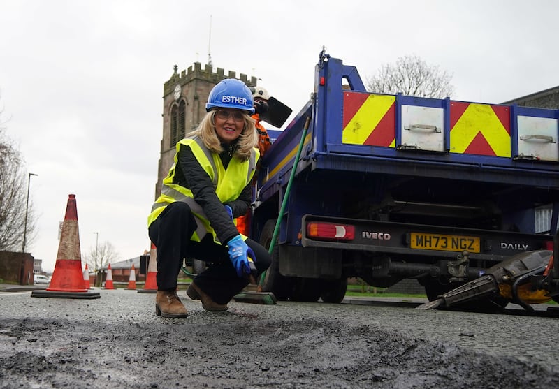Minister without Portfolio Esther McVey helps repairs potholes in Leigh in Greater Manchester, as she called for councils to ‘get on with it’ and use the £8.3bn allotted to councils to fix potholes