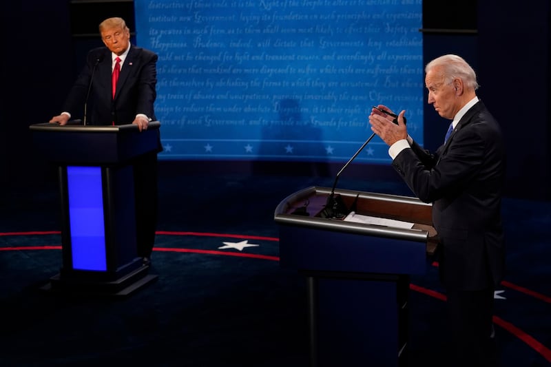 Joe Biden, right, answers a question as Donald Trump listens during the second and final presidential debate in 2020 (Morry Gash/AP)
