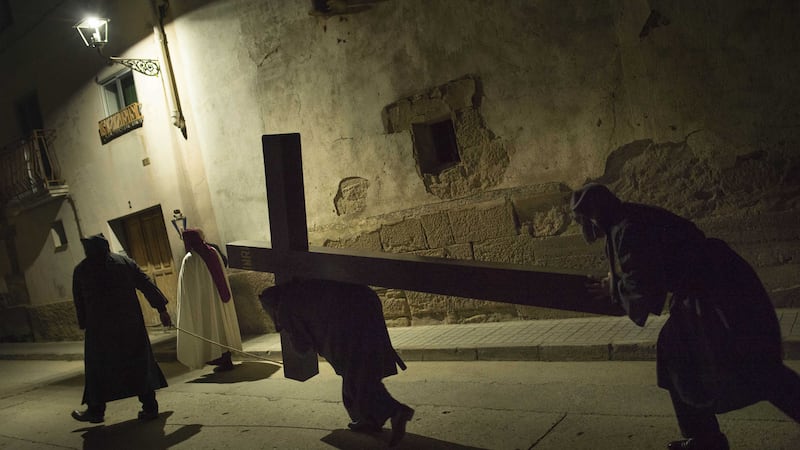 Masked penitents carrying a cross as they take part in the procession of the Ensogado, during Holy Week in Sietamo, northern Spain. Picture by Alvaro Barrientos, Associated Press&nbsp;