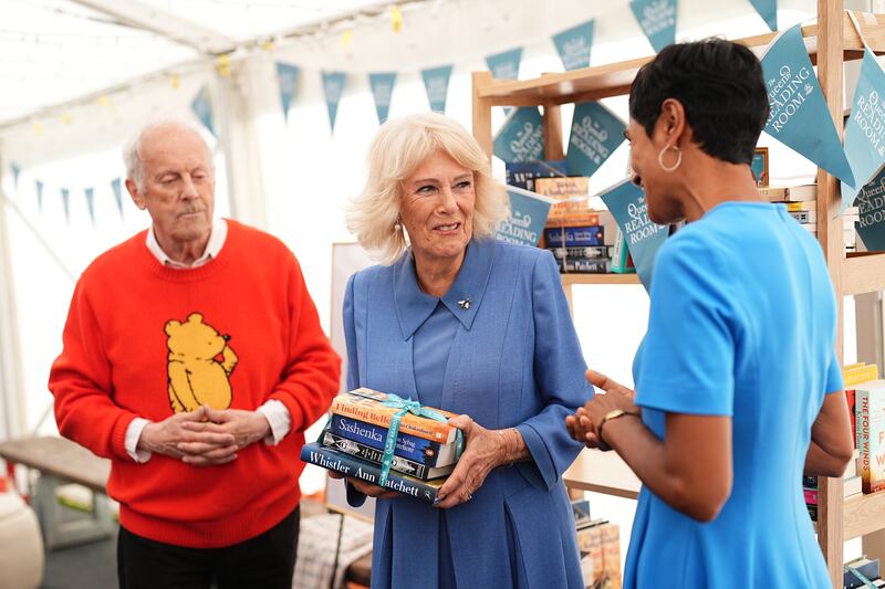 Queen Camilla with Gyles Brandreth speaking to author Reeta Chakrabarti