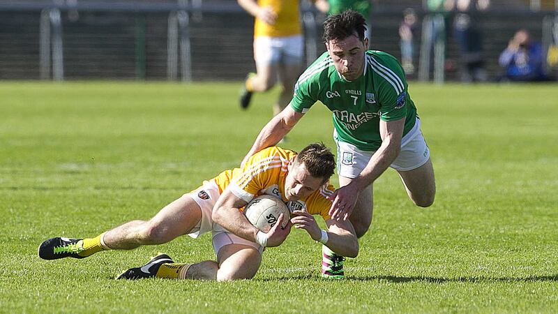 Antrim's Mark Sweeney goes to ground under pressure from Fermanagh's Barry Mulrone during last Sunday's Ulster SFC opener in Brewster Park<br />Picture by Philip Walsh&nbsp;