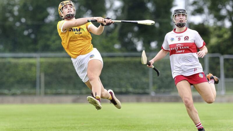 Antrim&#39;s Maeve Kelly fires a score over the bar ahead of Megan Kerr of Derry during the Ulster Senior Camogie Championship semi final at Loughgiel on Saturday Picture: Margaret McLaughlin. 