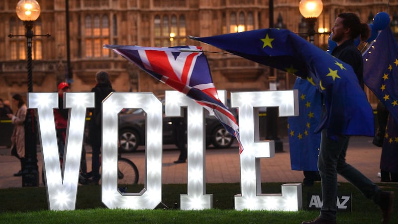 Anti-Brexit protestors with an illuminated sign reading 'Let Us Vote' outside the Houses of Parliament, London&nbsp;