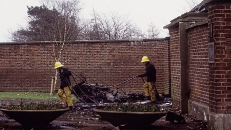 Firemen at the scene of a bomb attack at Roselawn Cemetery in east Belfast in March 1987. Picture: Pacemaker 