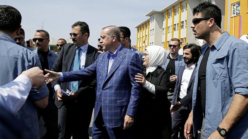 Turkey&#39;s President Recep Tayyip Erdogan, centre, and his wife Emine greet supporters outside a polling station in Istanbul on Sunday. Picture by Emrah Gurel/AP 