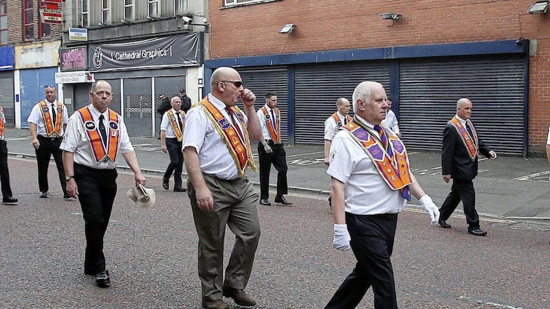 Orangeman John Aughey (right) marches through Donegall Street on the Twelfth after being released from jail earlier this year. Picture by Mal McCann 