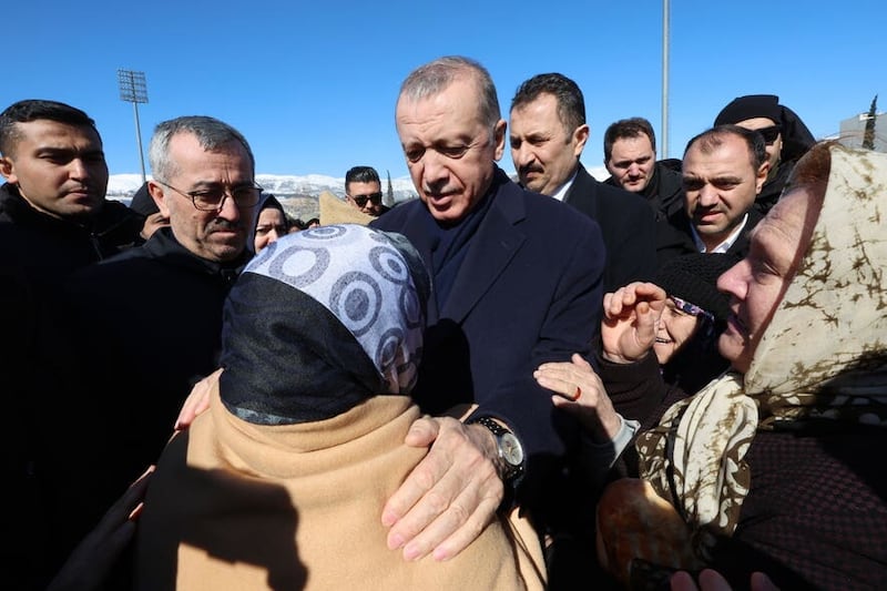  Erdogan speaks to a survivor during a visit to Kahramanmaras in southern Turkey last year (Turkish Presidency/AP)