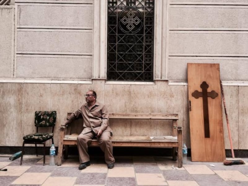 Man sits outside the church