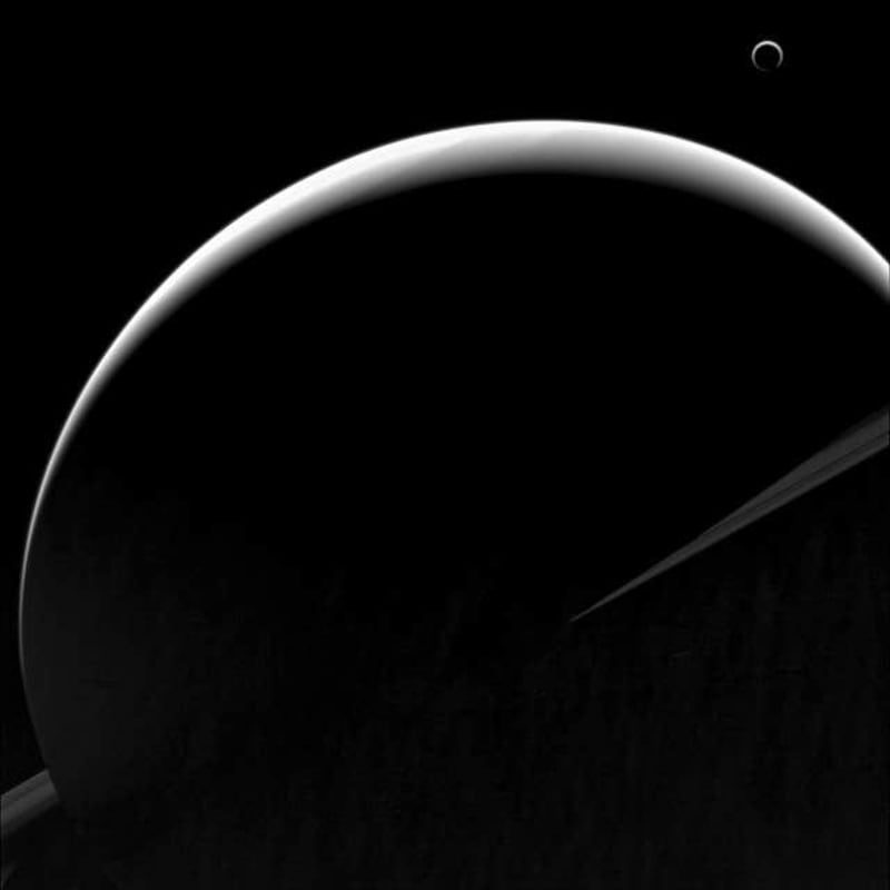 Saturn and one if its moons, Titan, seen from the Cassini spacecraft
