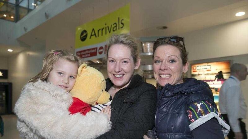 Donegal woman Leanne Doherty (left) welcomes home sister Olette Gummer (right) and Olette's four year old daughter Emily from Australia