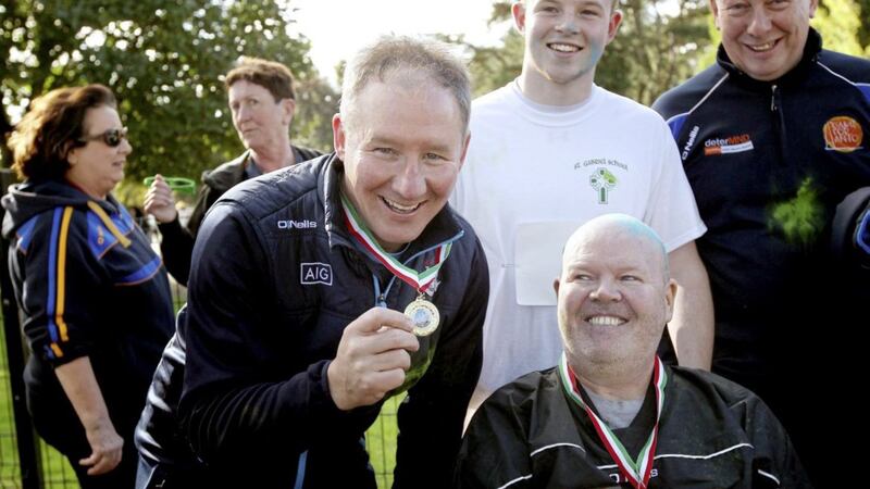 Anto Finnegan with former Dublin boss Jim Gavin, who proudly shows off his medal after completing the &#39;Run for Anto&#39; at Falls Park in 2018. Picture by Ann McManus 