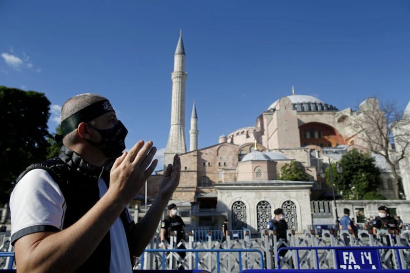 A Muslim man prays outside Hagia Sophia - a former cathedral-turned-mosque that became a museum in 1934 - in Istanbul. Turkey&#39;s highest administrative court ruled last Friday that the 6th century Byzantine building could be turned back into a Muslim house of worship. Pope Francis said he was &quot;deeply pained&quot; at the decision. Picture by AP Photo/Emrah Gurel 
