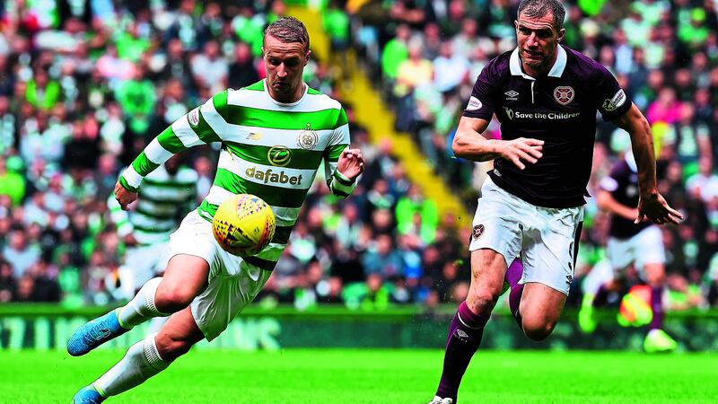 Celtic's Leigh Griffiths and Aaron Hughes of Hearts in a race for possession during Celtic's 4-1 win on Saturday