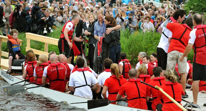 The Duchess of Cambridge is hugged by the Duke of Cambridge after a boat race across a lake on Prince Edward Island, eastern Canada