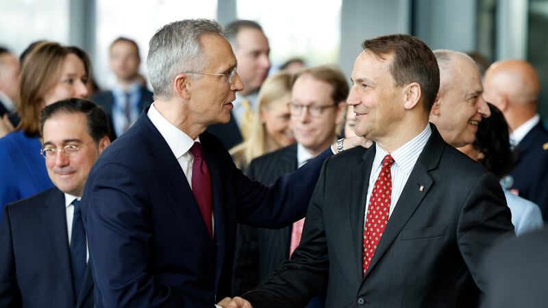 Nato Secretary General Jens Stoltenberg shakes hands with Poland’s Foreign Minister Radoslaw Sikorski (Geert Vanden Wijngaert/AP)