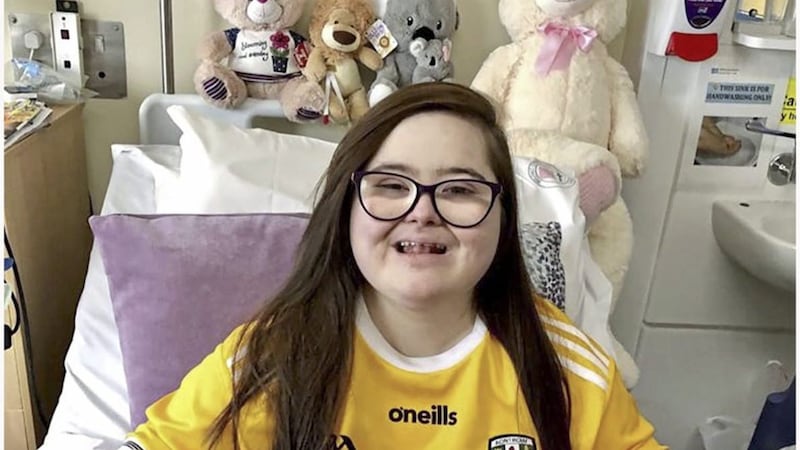 Tierna McMullan was admitted to hospital six weeks ago. She is pictured wearing an Antrim GAA jersey signed by its senior hurlers 