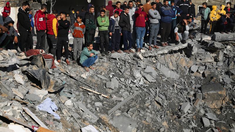 Palestinians view the destruction after Israeli bombardment outside a morgue in Rafah (Hatem Ali/AP)