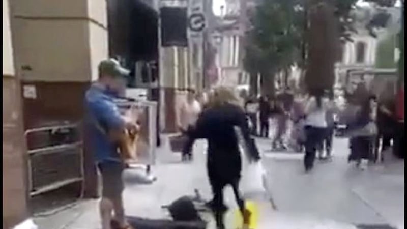 A woman kicked the busker&#39;s microphone stand and other equipment during as he sang Grace 