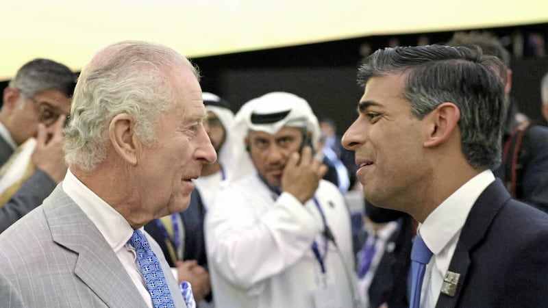 King Charles III, wearing a tie emblazoned with the Greek flag, speaks with Prime Minister Rishi Sunak as they attend the opening ceremony of the World Climate Action Summit at Cop28 in Dubai 