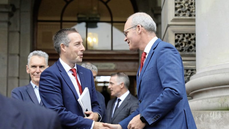 First Minister Paul Givan greets Minister for Foreign Affairs Simon Coveney during an event hosted by the Presbyterian Church to mark the centenary of Northern Ireland at Union Theological College, Belfast. Photo: Peter Morrison/PA Wire. 