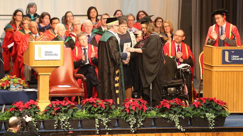 Leah Batchelor who recovered from locked-in syndrome on stage at Ulster University at Jordanstown to receive her degree&nbsp;