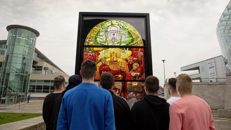 Members of the public take a close look at the second giant stained glass window unveiled in Belfast to mark the start of the final season of Game Of Thrones. Picture by Mark Marlow 
