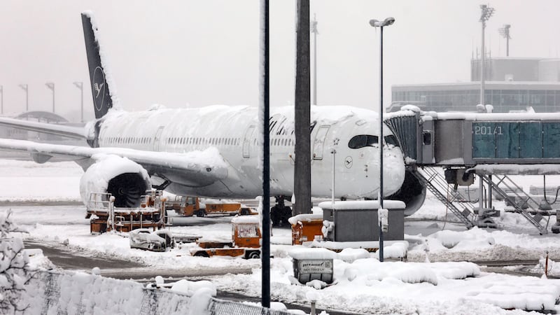 A Lufthansa aircraft parked at the snow-covered Munich airport in Germany (Karl-Josef Hildenbrand/dpa via AP)