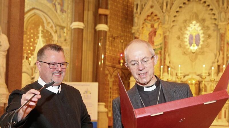 HOSPITALITY: Clonard Rector Fr Noel Kehoe presents the Archbishop with a gift on a visit to Clonard Monastery 