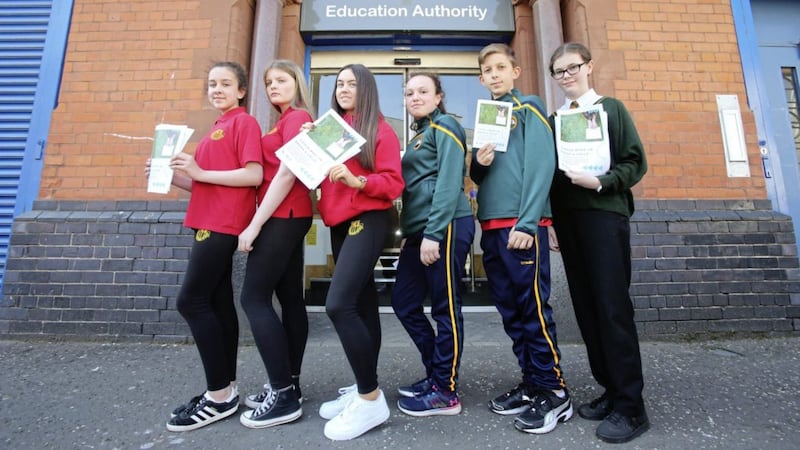 Pupils from Col&aacute;iste Feirste and Girls Model deliver the report to the Education Authority 