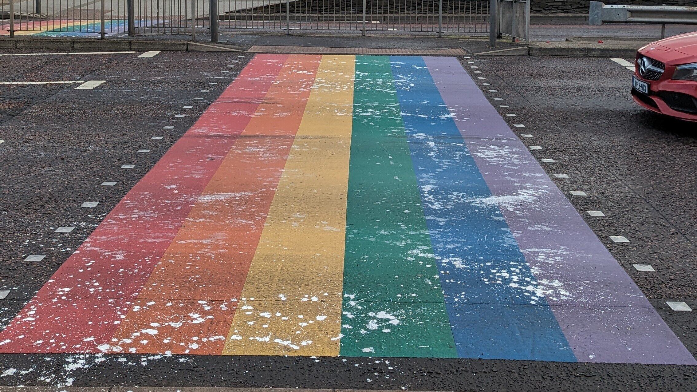 White paint was daubed on Derry's rainbow crossing in what police have described as a hate crime. 