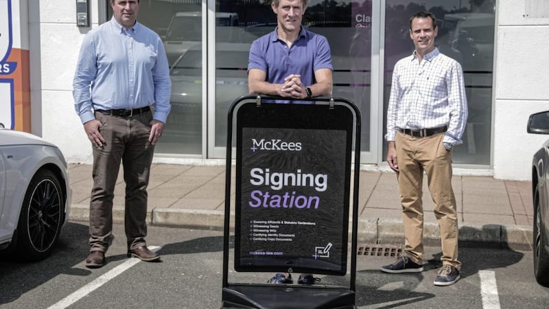 Chris Ross (managing partner) and Donald Thompson (partner) pictured at the launch of law firm McKee&rsquo;s new pop-up signing station with client Paul McGuire (centre), director of Traction Finance 