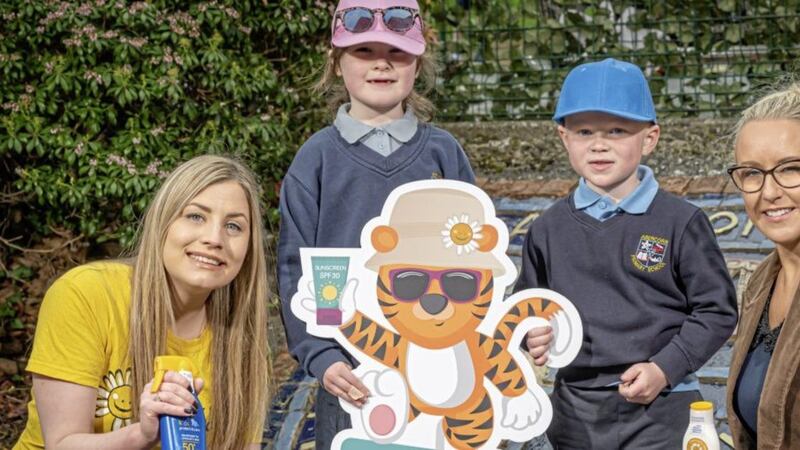 From left, Rebecca Oates from Cancer Fund for Children and Melanie Talbot of Gordons Chemists bring the campaign to life with the help of Primary One pupils from Abercorn Primary School in Banbridge 
