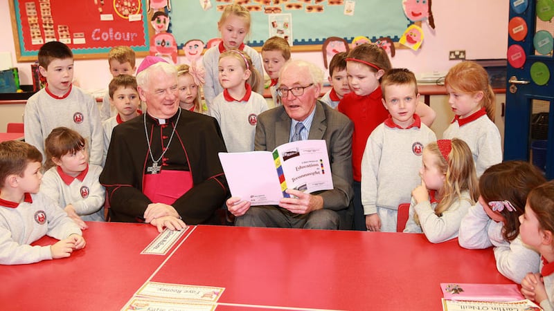 Denis Cahill launching his book on a short history of education in Teconnaught pictured with Bishop Noel Treanor and pupils from Holy Family Primary School. Picture by Bill Smyth