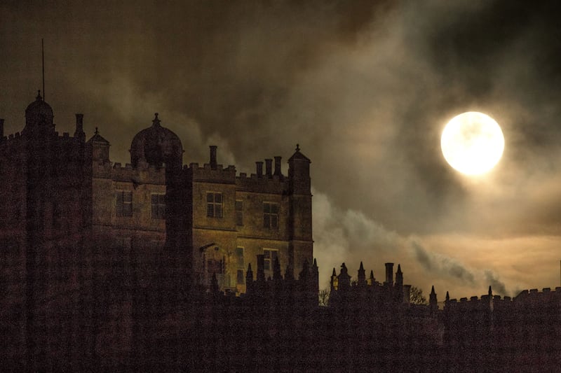 Incredibly bright moon above a stately home