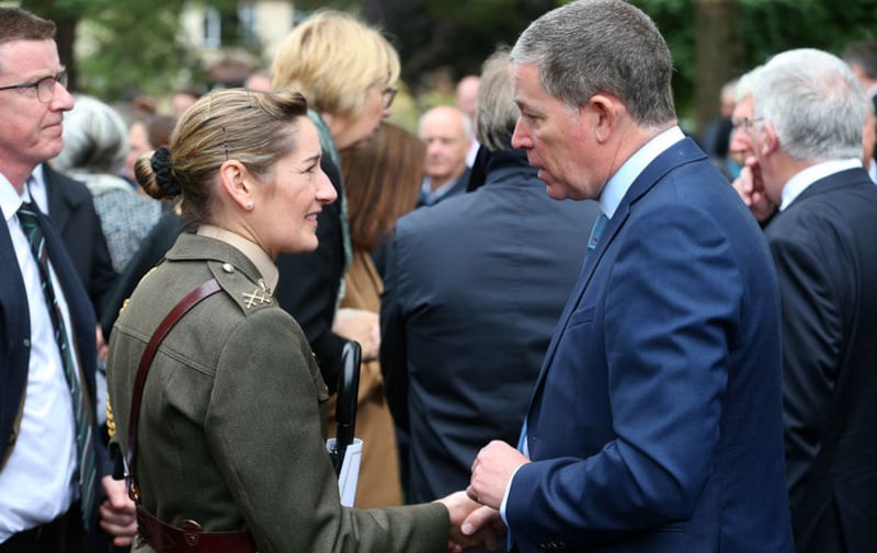 Commandant Claire Mortimer (left) Aide De Camp representing the Taoiseach speaks to Dominic Fitzpatrick (right), son of James Fitzpatrick at the funeral of his father and long-time owner of the Irish News, at St Brigid's Parish Church, Belfast. Picture by Mal McCann&nbsp;