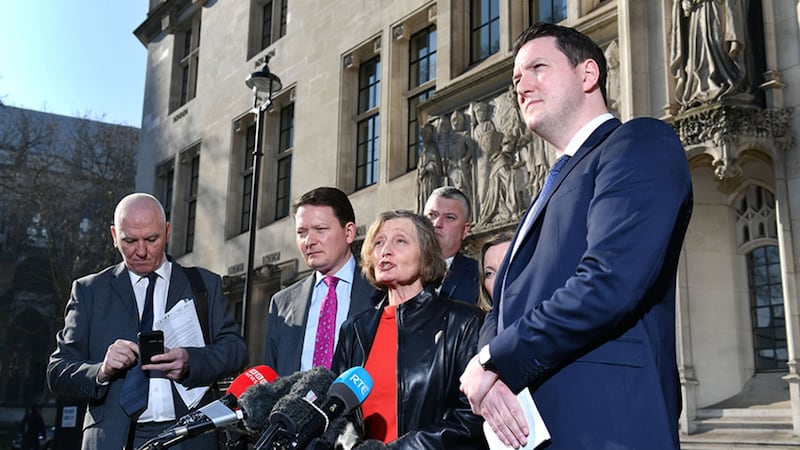 Geraldine Finucane, the widow of murdered Belfast solicitor Pat Finucane, accompanied by her sons John (right) and Michael (second left) speaks with reporters outside the Supreme Court in central London, after the family lost a challenge over the decision not to hold a public inquiry into his killing, but won a declaration that an effective investigation into his death has not been carried out&nbsp;