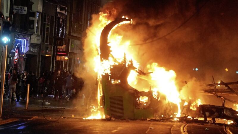 A bus on fire on O&#39;Connell Street in Dublin city centre on Thursday after violent scenes unfolded following an attack on Parnell Square East where five people were injured, including three young children. PICTURE: BRIAN LAWLESS/PA 