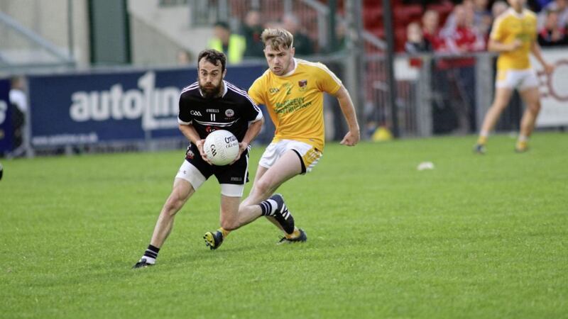 Kilcoo&#39;s Conor Laverty and Paul Lively of Clonduff in action during the Down SFC round one clash at Pairc Esler 
