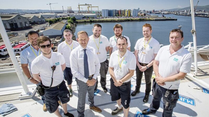 Members of the MJM Group&#39;s design, quantity surveying and contracts management teams with chief executive Gary Annett (front second left) on board the Azamara Pursuit, which the firm is currently refitting at Harland &amp; Wolff in Belfast 