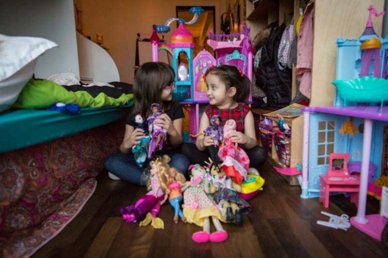 Salma Bokhari, age 5, and Grace Fetterman, also age 5, play with Graces dolls while 
