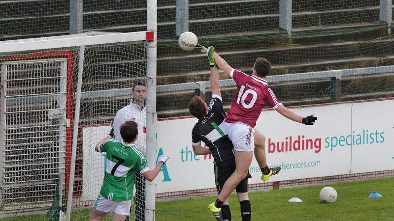 Shane McGuigan rises above Loup goalkeeper Thomas Mallon to score Slaughtneil&rsquo;s first goal in their 2-11 to 0-6 Derry SFC final victory at Celtic Park yesterday.&nbsp;Pictures by Margaret McLaughlin