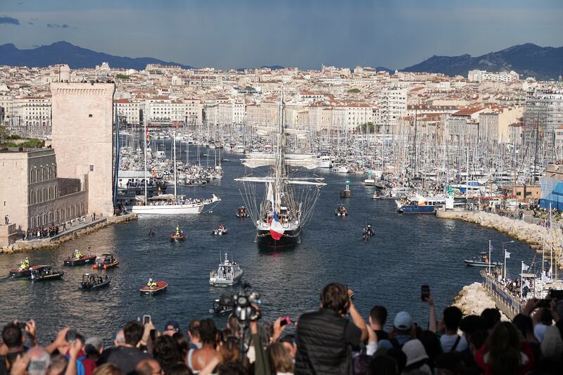 Crowds watch as the Belem, the three-masted sailing ship bringing the Olympic flame from Greece, enters Marseille (Laurent Cipriani/AP)
