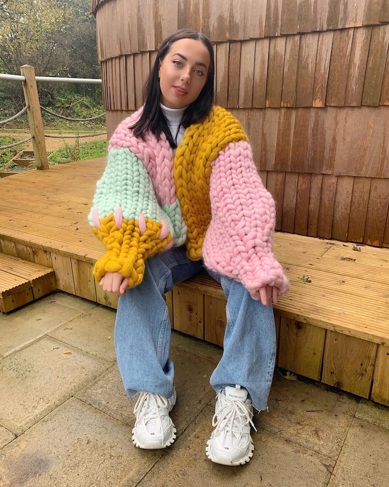 North Coast-based fashion designer Hope Macaulay wearing one of her own knitwear pieces, the Bella Colossal Knit in merino wool