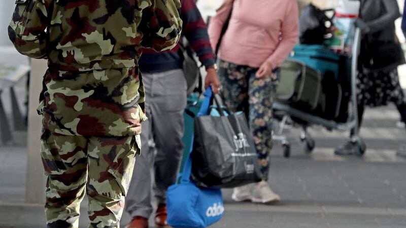 A member of the defence forces directs passengers arriving at <span class="red">Dublin</span> Airport from one of 33 high risk countries who will be transported to a mandatory 12-day hotel quarantine. Picture by Brian Lawless/PA Wire