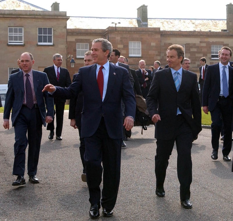 Then President George Bush, accompanied by Prime Minister Tony Blair, leaving Hillsborough Castle after talks