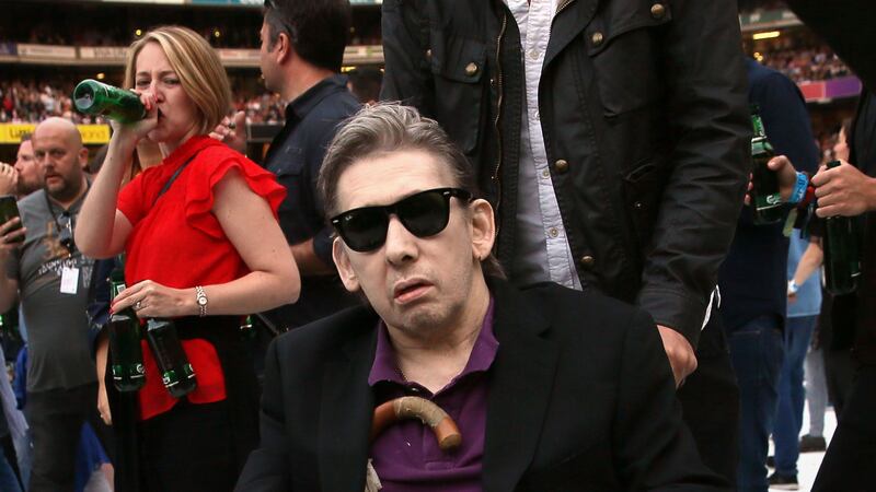 The Pogues frontman took to the stage in his wheelchair.