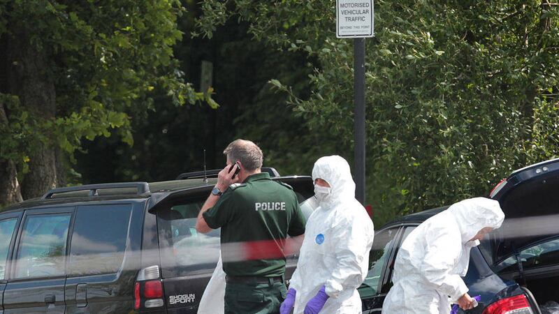 Police and forensics at the scene of where the bomb was found under the car of a PSNI officer in Co Derry 