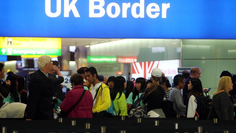 Passengers going through UK Border at Heathrow Airport, as new figures show migration to Britain at record levels 