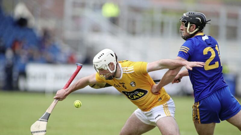 Golden moment. Antrim&#39;s Paddy Burke holds off Clare&#39;s Shane Golden. Picture by Hugh Russell. 