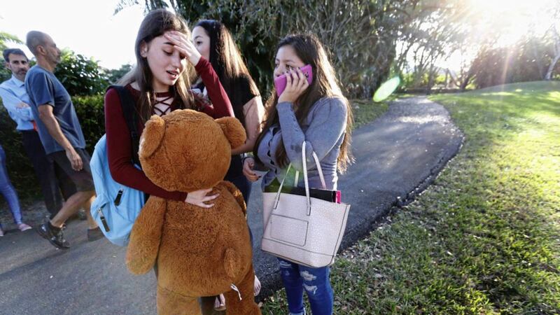 Students wait to be picked up after the high school mass shooting in Florida earlier this month 